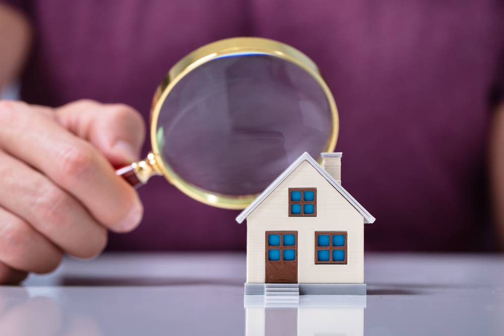 house model seen through magnifying glass